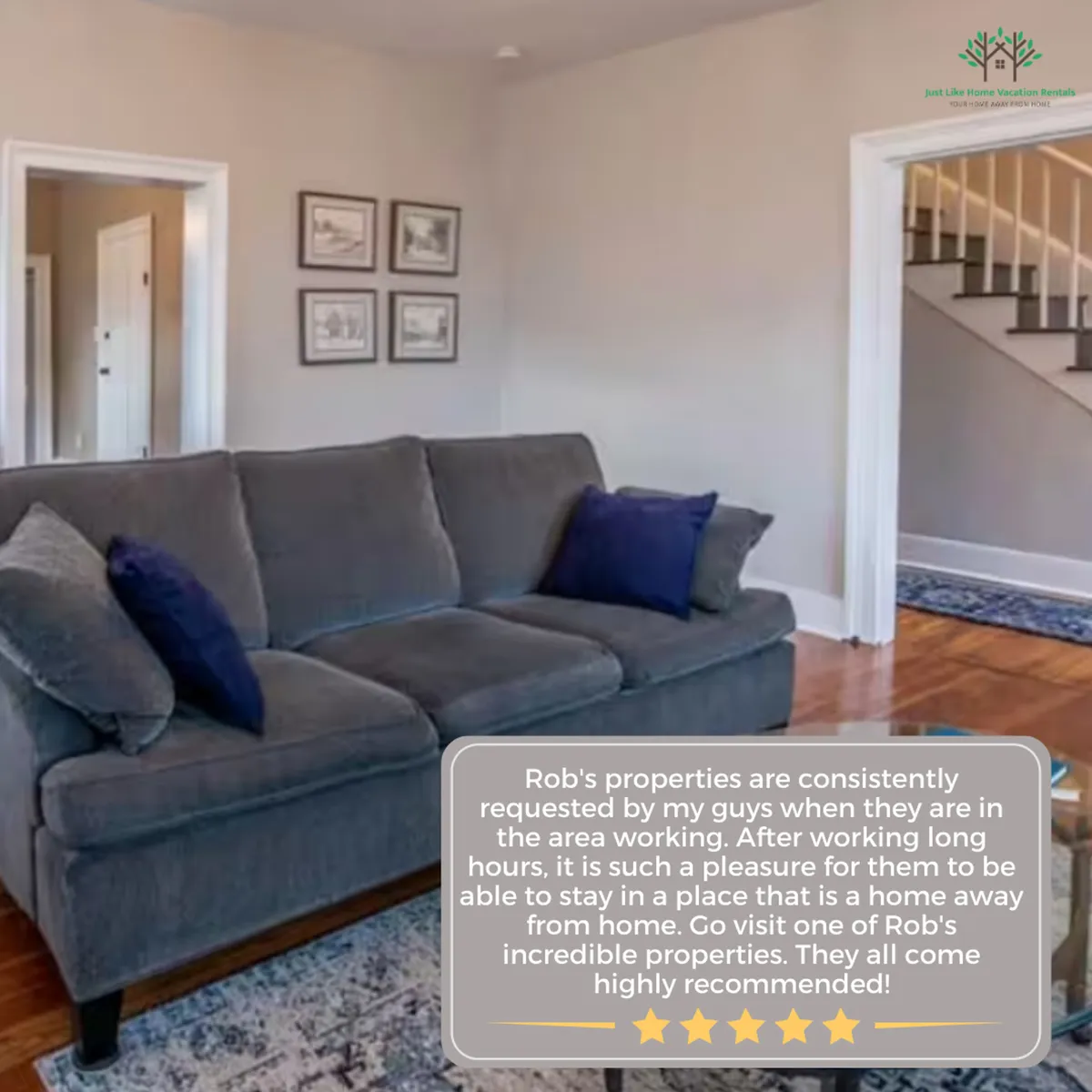 This image features a stylish living room with a plush sofa adorned with decorative pillows, tasteful wall art, and a staircase visible in the background. The room exudes comfort and warmth, inviting relaxation and socialization.